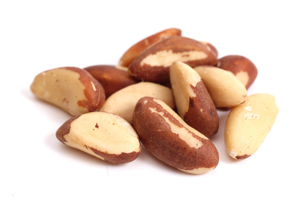 Pile of Brazil nuts on a white background