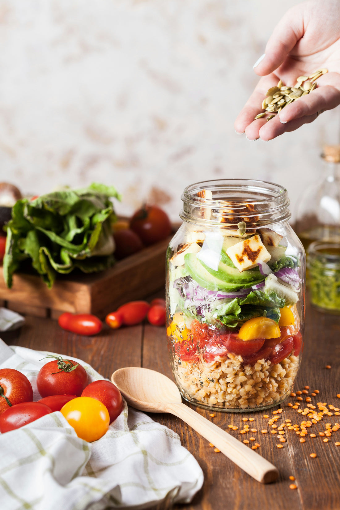 Real Food ingredients, seeds, nuts ,avocado, red cabbage being added to a large jar